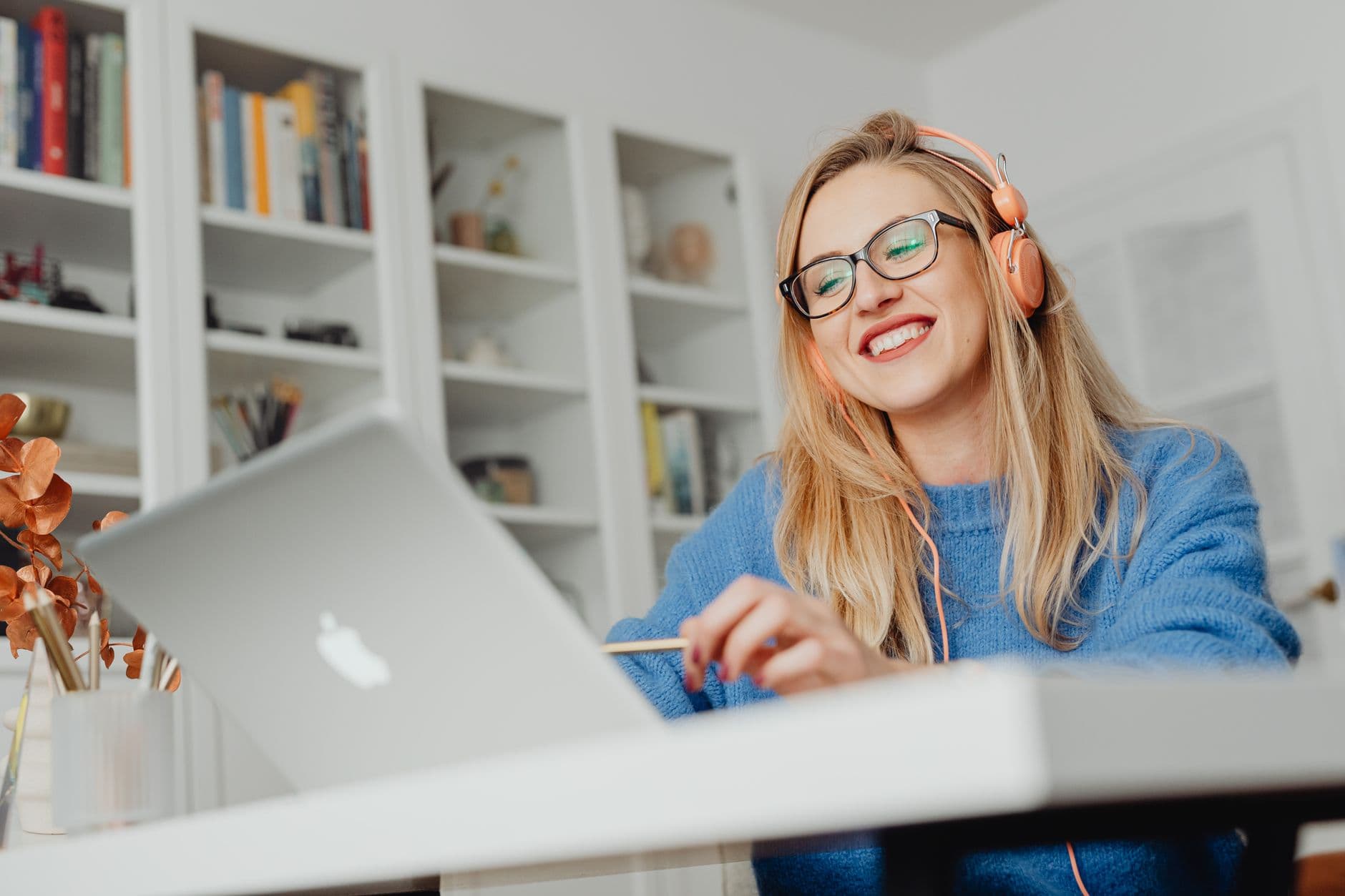 Happy web hosting customer smiling at laptop